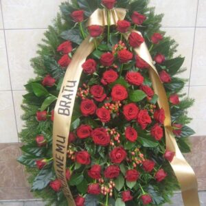 Wieniec pogrzebowy łezka z czerwonych róż i owoców hypericum ze złotą szarfą.